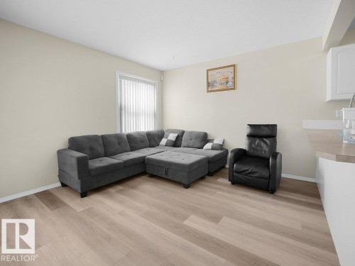 Living room featuring light wood-style floors - 196 230 Edwards Drive, Edmonton, AB - Indoor Photo Showing Living Room