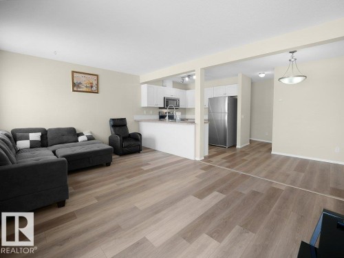 Living room with light wood-type flooring - 196 230 Edwards Drive, Edmonton, AB - Indoor Photo Showing Living Room