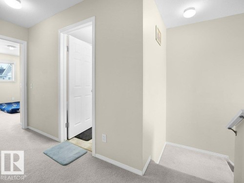 Corridor featuring light colored carpet and baseboards - 196 230 Edwards Drive, Edmonton, AB - Indoor Photo Showing Other Room