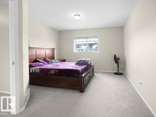Bedroom featuring light carpet and baseboards - 196 230 Edwards Drive, Edmonton, AB - Indoor Photo Showing Bedroom