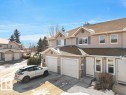 Traditional-style house featuring roof with shingles, driveway, a residential view, and a garage - 196 230 Edwards Drive, Edmonton, AB  - Outdoor With Facade 