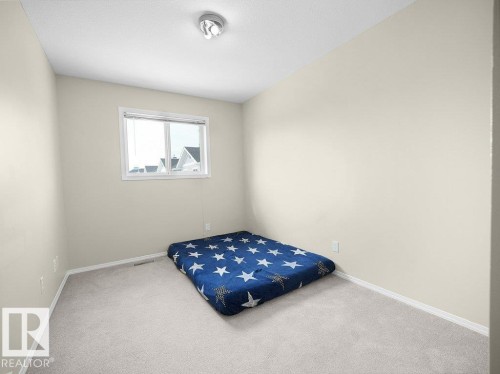 Carpeted bedroom featuring baseboards - 196 230 Edwards Drive, Edmonton, AB - Indoor Photo Showing Bedroom