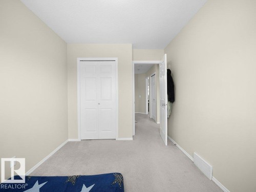 Unfurnished bedroom with light carpet and a closet - 196 230 Edwards Drive, Edmonton, AB - Indoor