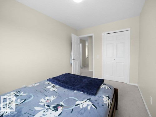Carpeted bedroom featuring baseboards and a closet - 196 230 Edwards Drive, Edmonton, AB - Indoor Photo Showing Bedroom