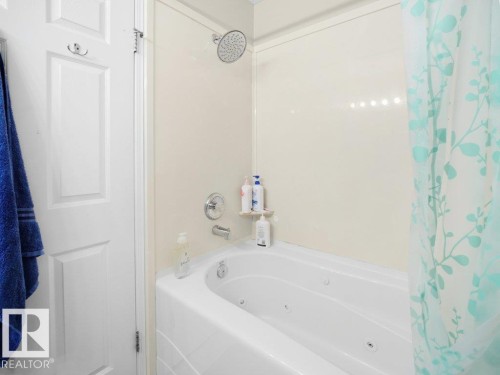 Bathroom with a combined bath / shower with jetted tub - 196 230 Edwards Drive, Edmonton, AB - Indoor Photo Showing Bathroom