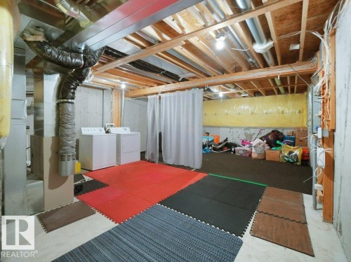 Unfinished below grade area with washer and clothes dryer - 196 230 Edwards Drive, Edmonton, AB - Indoor Photo Showing Basement