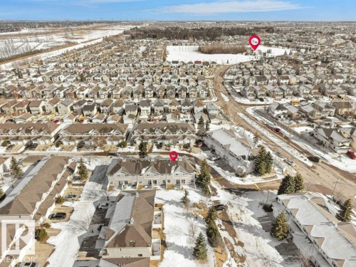 Snowy aerial view featuring a residential view - 196 230 Edwards Drive, Edmonton, AB - Outdoor With View