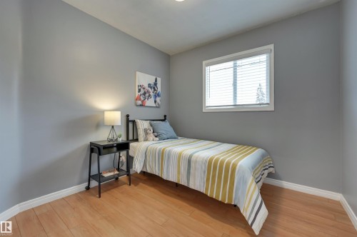 Bedroom with light wood finished floors and baseboards - 13932 118 Avenue, Edmonton, AB - Indoor Photo Showing Bedroom