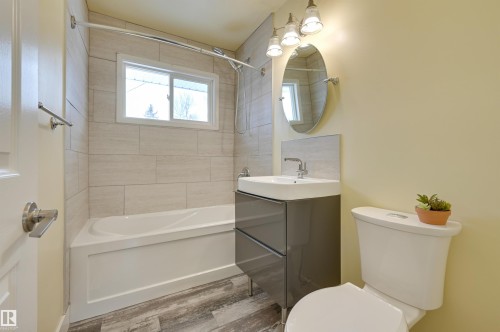 Bathroom featuring vanity, shower / tub combination, and wood finished floors - 13932 118 Avenue, Edmonton, AB - Indoor Photo Showing Bathroom