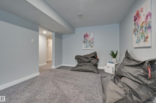Sitting room featuring baseboards and light colored carpet - 13932 118 Avenue, Edmonton, AB - Indoor