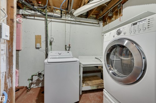 Laundry room with unfinished concrete flooring and washing machine and clothes dryer - 13932 118 Avenue, Edmonton, AB - Indoor Photo Showing Laundry Room