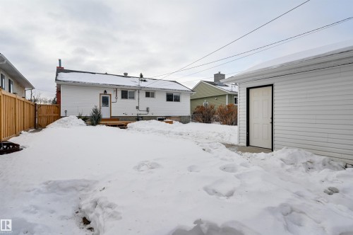 Snow covered back of property with a deck - 13932 118 Avenue, Edmonton, AB - Outdoor With Exterior