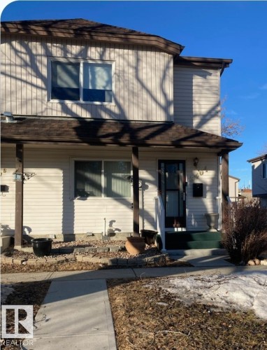 The property features a two-story exterior with light-colored siding and a covered front porch - 5404 146 Avenue Nw, Edmonton, AB - Outdoor