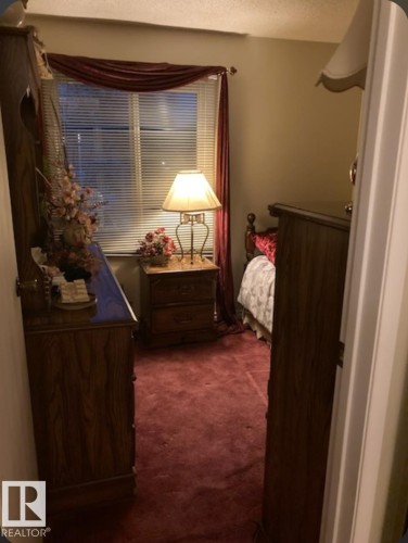 This room features rich red carpeting and a window with blinds and red drapery - 5404 146 Avenue Nw, Edmonton, AB - Indoor