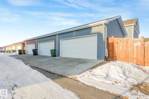 This property features a garage with a white door and blue siding - 1920 24 Street, Edmonton, AB - Outdoor