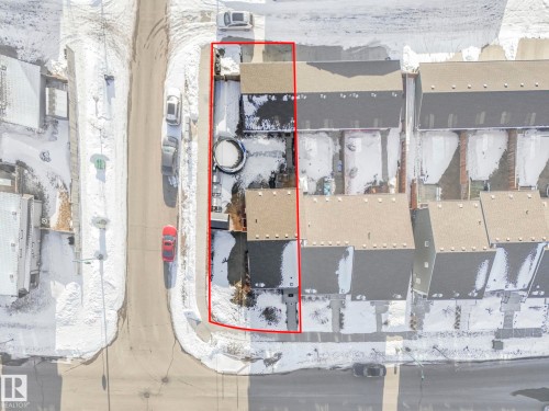 Aerial view of the property, outlined in red, featuring a rectangular lot, a paved driveway, and a residential street - 1920 24 Street, Edmonton, AB - Other