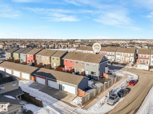 Aerial view showcasing the property within a residential neighborhood featuring several homes with various exterior colors and a row of detached garages - 1920 24 Street, Edmonton, AB - Outdoor
