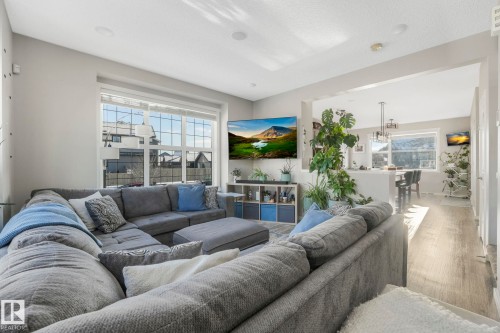 The living room features large windows, light gray walls, and recessed lighting - 1920 24 Street, Edmonton, AB - Indoor Photo Showing Living Room