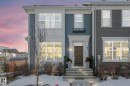The property features a multi-story facade with light-colored trim and a dark-colored front door - 1920 24 Street, Edmonton, AB  - Outdoor With Facade 