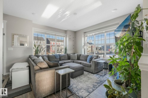 Living area featuring large windows providing natural light, recessed lighting, and light-toned walls - 1920 24 Street, Edmonton, AB - Indoor Photo Showing Living Room