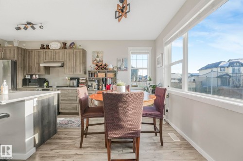 The property features a kitchen and dining area with light-toned flooring and walls - 1920 24 Street, Edmonton, AB - Indoor