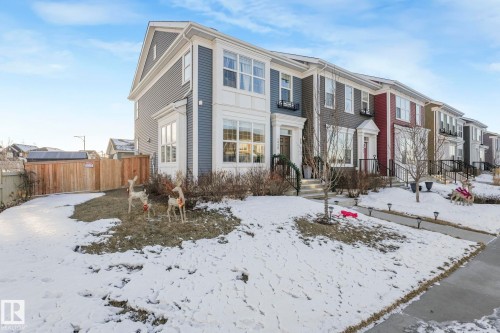 The property features a two-story facade with bay windows, siding, and a fenced yard - 1920 24 Street, Edmonton, AB - Outdoor With Facade