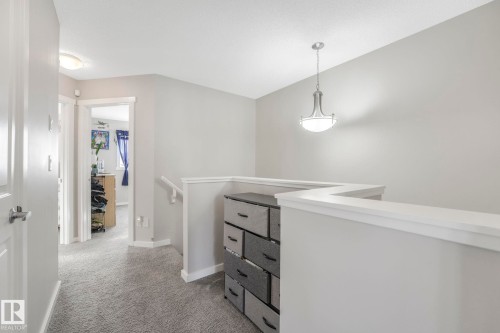 The property features a staircase with a white railing and light gray walls - 1920 24 Street, Edmonton, AB - Indoor Photo Showing Other Room