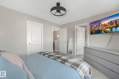 This room features a modern black ceiling fan, light gray walls, and white paneled doors - 1920 24 Street, Edmonton, AB - Indoor Photo Showing Bedroom