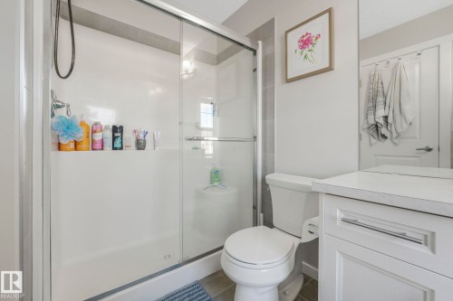 The bathroom features a spacious shower with glass enclosure and tiled accents - 1920 24 Street, Edmonton, AB - Indoor Photo Showing Bathroom