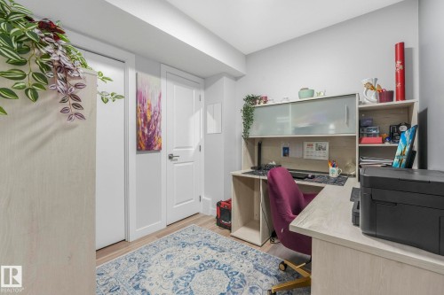 This room features light-colored flooring, white walls, and a desk with shelving - 1920 24 Street, Edmonton, AB - Indoor