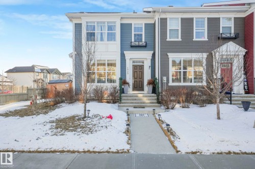 This property features a contemporary exterior with blue siding and white trim, complemented by a front walkway leading to a welcoming entrance - 1920 24 Street, Edmonton, AB - Outdoor With Facade