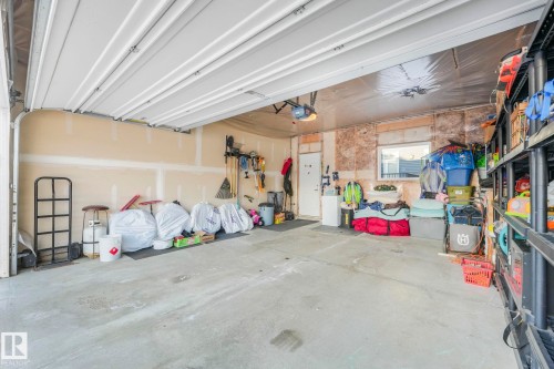 Attached garage featuring a concrete floor and a white paneled garage door - 1920 24 Street, Edmonton, AB - Indoor Photo Showing Garage