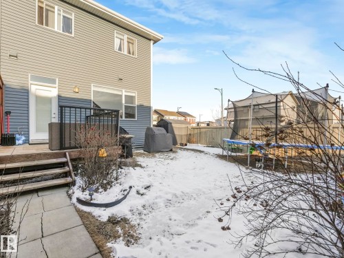The property features a two-story exterior with horizontal siding and a ground-level wooden deck - 1920 24 Street, Edmonton, AB - Outdoor