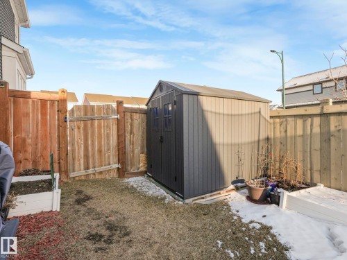 The property includes a fenced yard with a storage shed and raised garden beds - 1920 24 Street, Edmonton, AB - Outdoor With Exterior