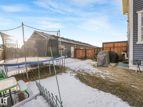 The property features a fenced yard with a combination of wooden and chain-link fencing, a siding exterior, and a small area of exposed earth - 1920 24 Street, Edmonton, AB - Outdoor With Exterior