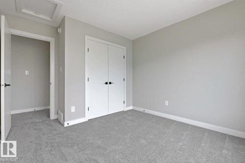 Neutral-toned room featuring grey carpeting and light grey walls - 30 Chartres Close Nw, St. Albert, AB 
