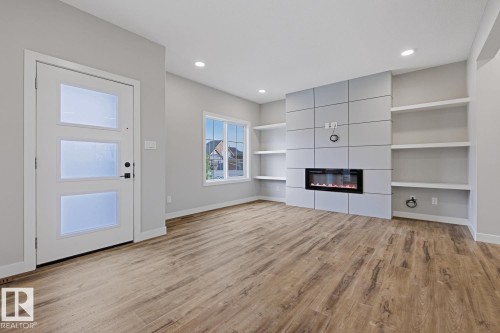 Living area featuring wood-finish flooring and recessed lighting - 30 Chartres Close Nw, St. Albert, AB 