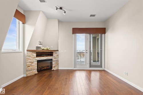 425 6083 Maynard Way, Edmonton, AB - Indoor With Fireplace