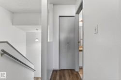 Hallway featuring dark wood-style floors and a textured ceiling - 
