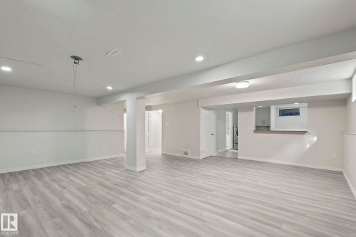 Expansive interior space featuring light-colored flooring, recessed lighting, and a neutral wall palette - 18124 68Ave, Edmonton, AB - Indoor