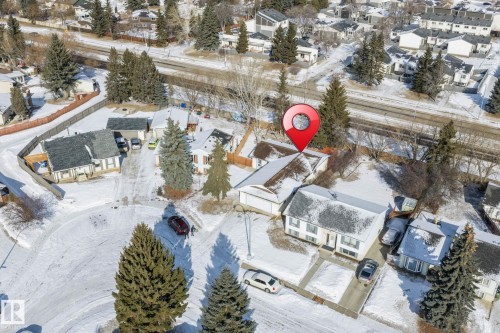 Aerial view of the property and its surrounding neighborhood, featuring several mature trees and residential homes - 18124 68Ave, Edmonton, AB - Outdoor With View