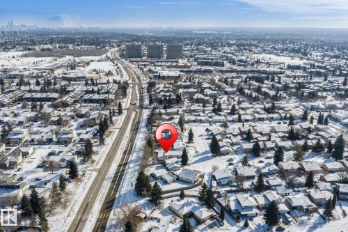 Aerial view of the property and surrounding neighborhood, featuring residential homes, mature trees, and a clear road - 18124 68Ave, Edmonton, AB - Outdoor With View