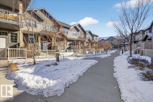 The property is part of a row of townhouses featuring a blend of siding and shingles on the exterior - 33 4029 Orchards Drive Sw, Edmonton, AB - Outdoor With Facade