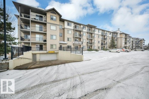 This property features a multi-story building with numerous private balconies and a neutral-toned exterior - 103 309 Clareview Station Drive, Edmonton, AB - Outdoor With Balcony With Facade