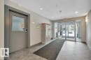 The property features a well-maintained entry area with a tiled floor, recessed lighting, and glass double doors at the entrance - 103 309 Clareview Station Drive, Edmonton, AB  - Indoor Photo Showing Other Room 