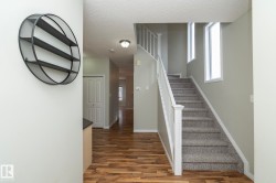 Stairway with wood finished floors and a textured ceiling - 