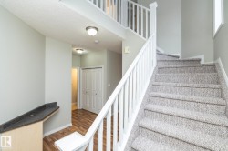 Stairway with a textured ceiling and wood finished floors - 