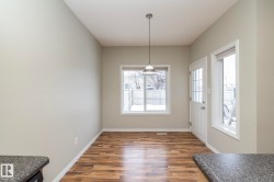 Unfurnished dining area featuring dark wood-type flooring and baseboards - 