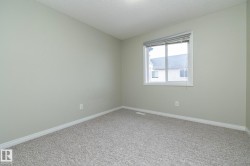 Carpeted empty room with baseboards and a textured ceiling - 