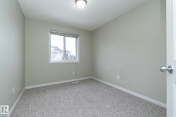 Empty room with baseboards and light colored carpet - 